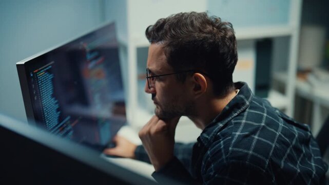 Focused caucasian software engineer works overtime late at night in modern tech office. Artificial intelligence, Dedicated freelance strategy, Database server debugging, Cybersecurity cloud concept.