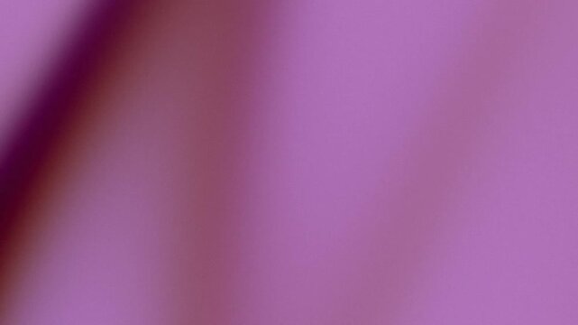 Soft focus purple and mauve gradient background with grainy texture.