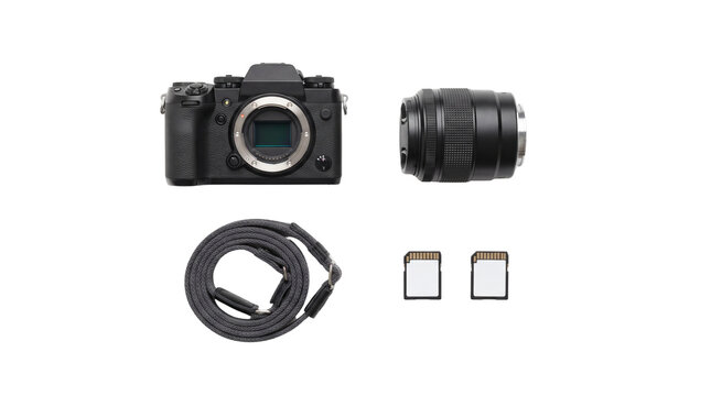 Mirrorless digital camera body with interchangeable lens, professional photography gear set, black camera equipment with strap and memory cards isolated PNG with Transparent Background