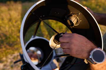 Amateur astronomer preparing telescope during sunset for night observations of stars, Milky Way, Moon and Planets. © astrosystem