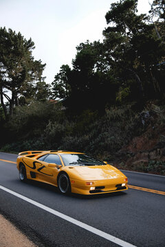 Editorial Title
Seaside, California, USA - August 17, 2024: A yellow Lamborghini Diablo SV supercar driving on a Highway 1 during Monterey Car Week