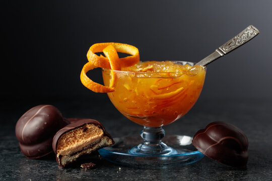 Chocolate dessert with orange marmalade and a glass bowl with orange jam.