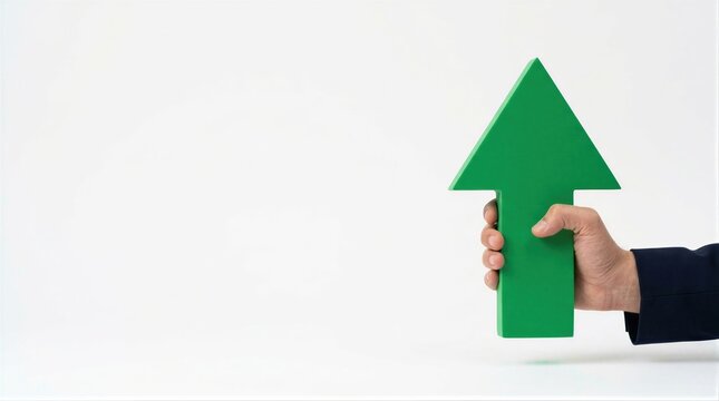 Business hand in navy suit sleeve holding green upward arrow against white background. Copy space beside arrow symbol. Growth, increase and success concept. Positive progress and improvement