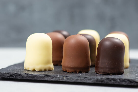 Chocolate teacakes, coated marshmallow treats, krembo, pastry sweets with cookies, fluffy cream and glaze, traditional winter dessert, food selection