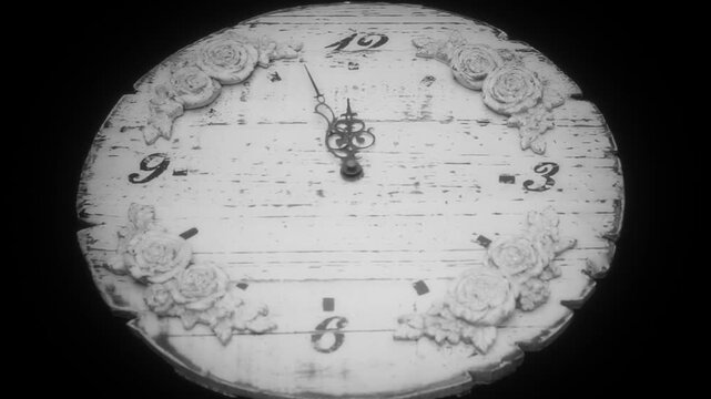 Antique clock hands reach midnight in black and white timelapse as red DEADLINE text appears. Vintage timepiece with floral details conveys urgency, countdown and time pressure for dramatic themes.