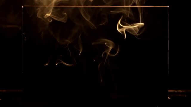 Golden smoke wisps drift and curl across a dark glass panel, creating flowing abstract motion with glowing amber highlights and elegant atmospheric texture