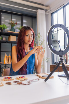 Asian business owner live streaming sell handcrafted jelvery