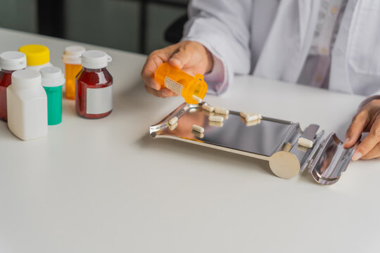  Mature Asian pharmacist using medication tray