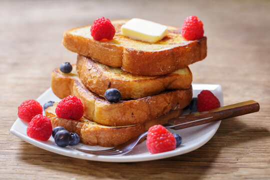 plate of french toasts with fresh berries