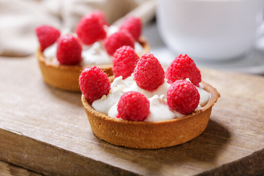Sweet dessert. Tartlets with cream and raspberrie