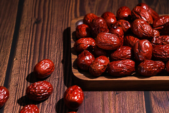 Dried Red Jujubes on Wooden Tray and Rustic Table