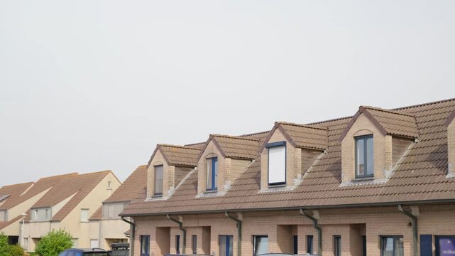 Brick house with gabled dormer windows and tiled roofs residential buildings district slow motion