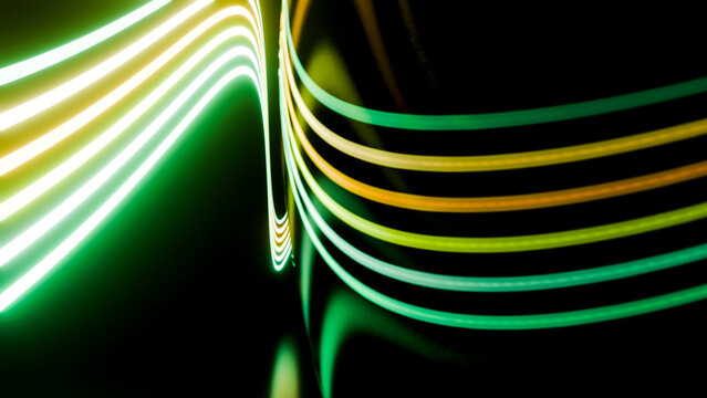 Abstract curved green and yellow light trails on dark background