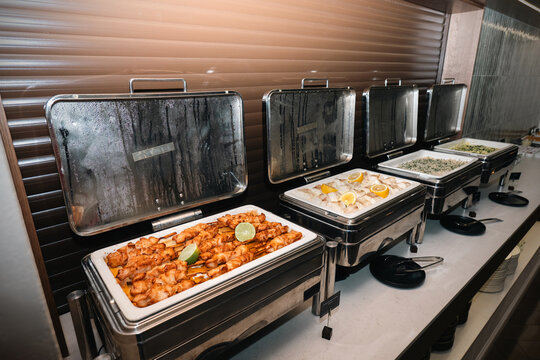Hotel buffet presentation with hot dishes in stainless steel chafing dishes