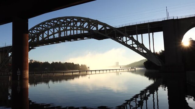Stockholm, Sweden A view of Arstaviken Bay and the Arsta train bridge on a cold and misty autumn morning, and the STHLM 01 tower in the distance. 