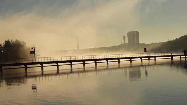 Stockholm, Sweden A view of Arstaviken Bay and the Arsta train bridge on a cold and misty autumn morning, and the STHLM 01 tower in the distance. 
