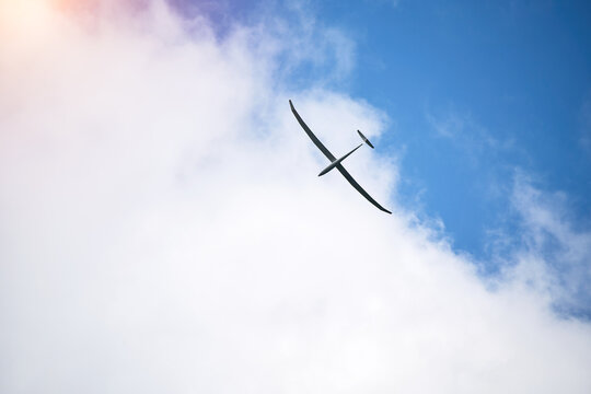 Lightweight glider winging across peaceful open air