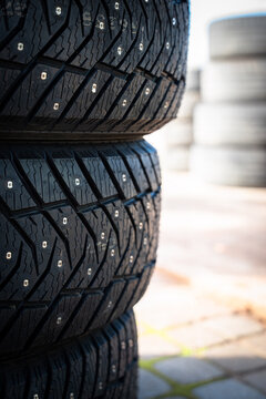 Stack of Studded Winter Car Tires with Copy Space for Seasonal Safety