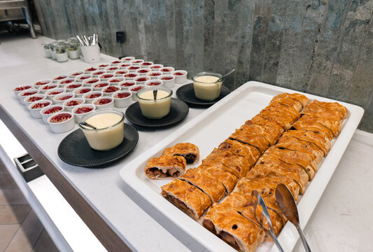 Sliced apple strudel and vanilla sauce on a hotel buffet dessert counter