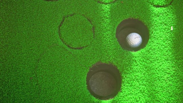 Ottawa, Ontario, Canada - October 20, 2026:  Golf ball in a cup on a practice putting green with Titleist brand visible