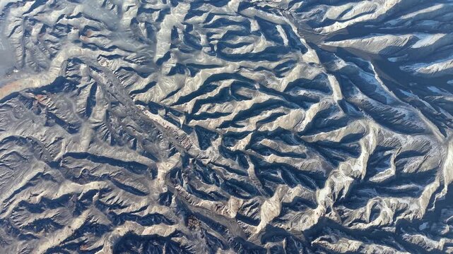 Aerial view of Mount Bromo volcanic ridges, ash textures, and eroded crater landscapes.