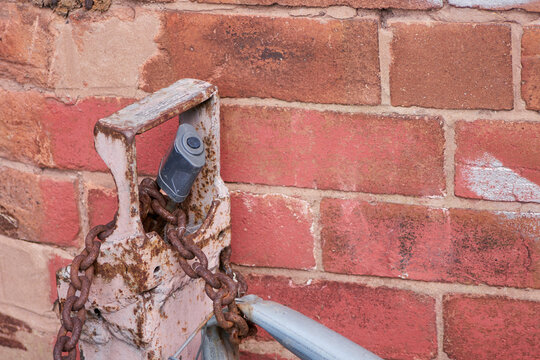 bashed security, chains, ironwork, padlock and brick wall