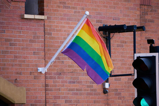 pride flag (slightly worn) with a green traffic light