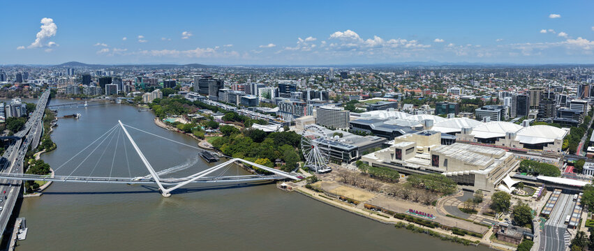 Aerial view of the Neville Bonner Bridge spanning the Brisbane River, with the South Bank Parklands, Queensland Performing Arts Centre, and the city skyline in Brisbane, Queensland, Australia.