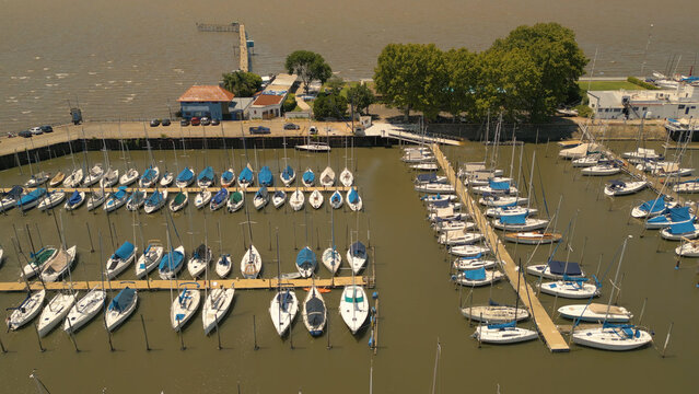 Aerial view of Puerto Olivos with numerous sailboats moored at the docks, surrounded by trees and buildings in Olivos, Provincia de Buenos Aires, Argentina.