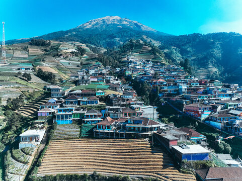 Aerial view of Nepal Van Java, a colorful village on the slopes of Mount Sumbing with terraced fields and vibrant houses in Kecamatan Kaliangkrik, Jawa Tengah, Indonesia.