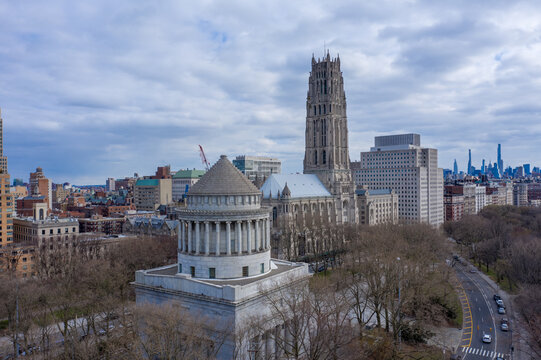 New York, United States - 02 April 2021: Aerial view of General Grant National Memorial and Riverside Church in Riverside Park, with the Manhattan skyline under a cloudy sky.