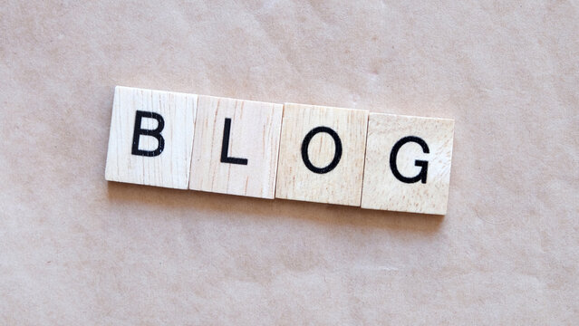 Wooden Letter Tiles Spelling Blog on a Neutral Beige Background