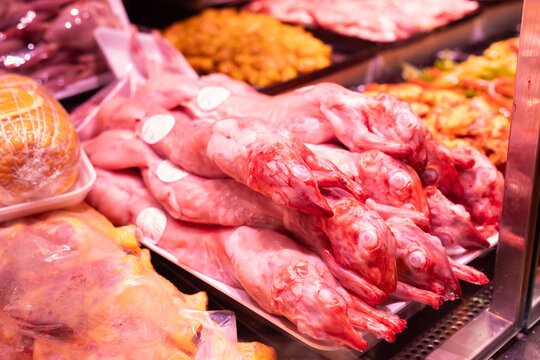 Meat department of supermarket - raw pig carcasses are on display in refrigerator
