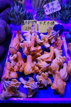 Orange Mushrooms on Sale at Kunming Market Under Blue Light