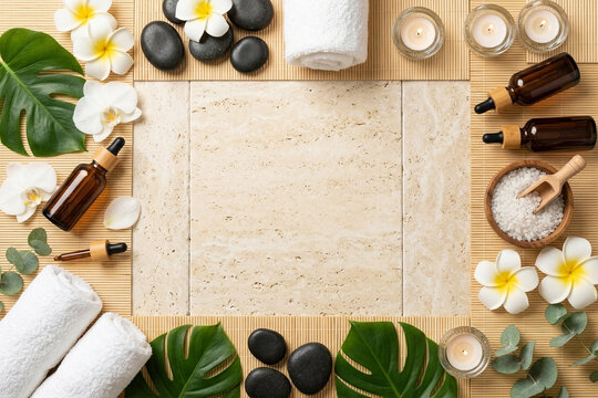 Top view 3D flat lay of organic spa aromatherapy with basalt stones, essential oil bottles, white orchids and towels framing travertine copy space