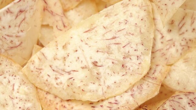 Pile of crispy fried taro chips slowly rotating. Top view shot