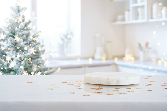Marble podium on kitchen counter with Christmas tree and festive lights in background