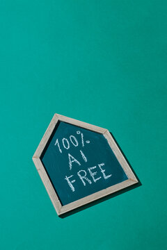 sign in the shape of a house and text 100% AI FREE