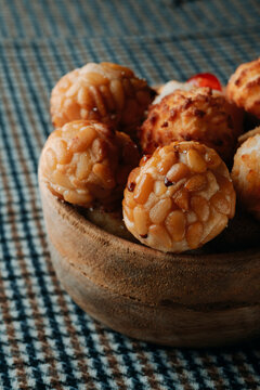 a close-up of pine nut panellets in a wooden bowl
