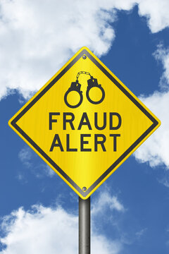Fraud Alert yellow warning sign with sky
