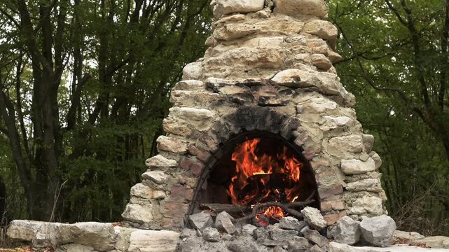 Fire burning in old outdoor stone oven with crackling sound