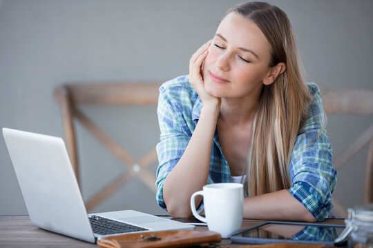 Tired Young Woman Taking a Break From Laptop Work
