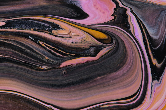 Swirling abstract liquid paint background featuring dark black, beige, and pink marble layers.