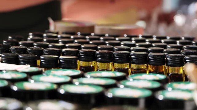 Rows of small amber bottles containing essential oil for aromatherapy and wellness