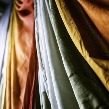 Silk fabric drape with multicolor folds creating luxurious textile texture