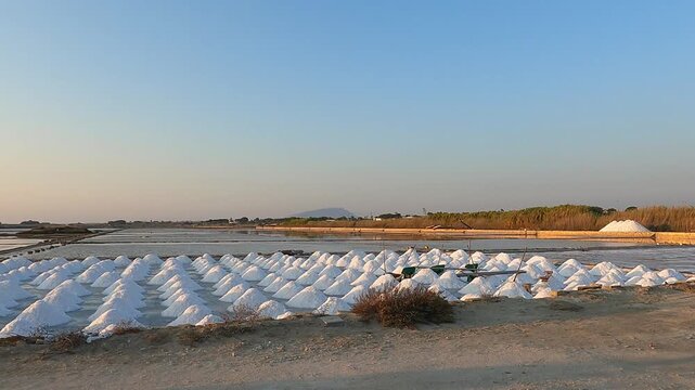 Golden sunset over tranquil salt pans near Trapani, Italy