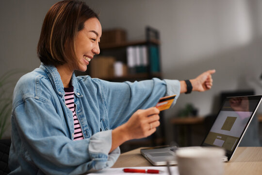Woman celebrating a successful online shopping payment
