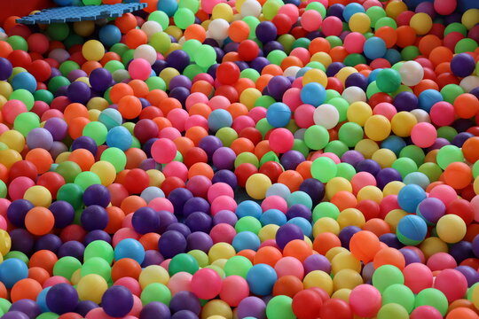 Pile of colorful small plastic balls creating a vibrant playful texture and background
