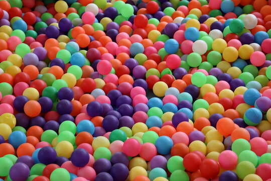 Pile of colorful small plastic balls creating a vibrant playful texture and background