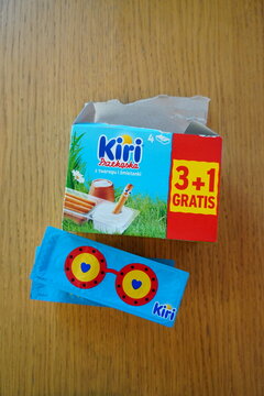 Open Kiri cheese snack box with colorful promotional insert on a wooden tabletop
